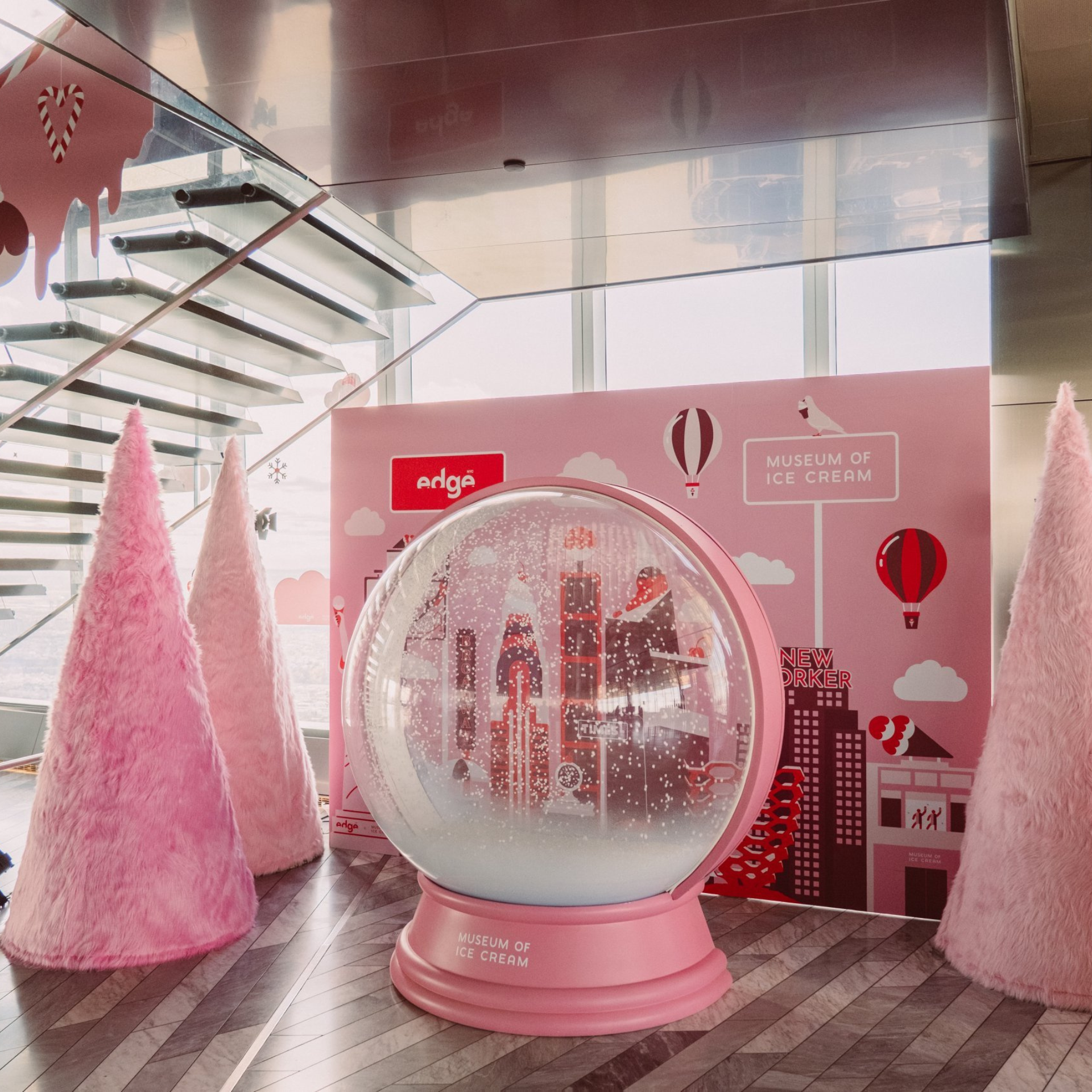 Whimsical indoor display at the Museum of Ice Cream with pink snow globe and furry cone sculptures