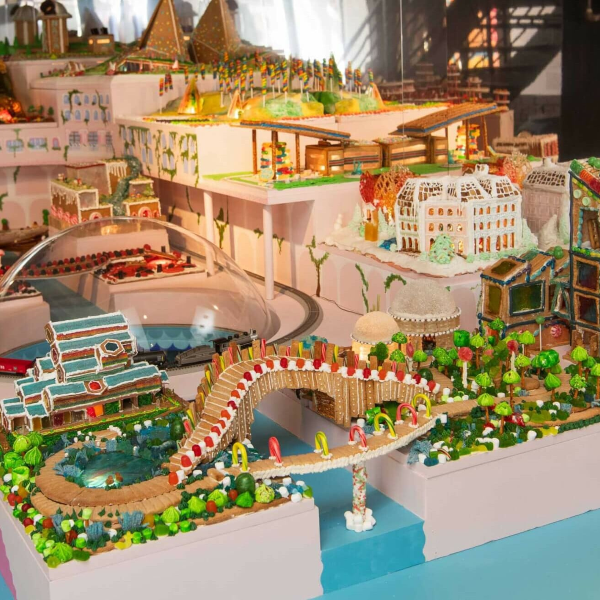 Colorful edible miniature cityscape made of gingerbread, candy, and icing with bridges and buildings