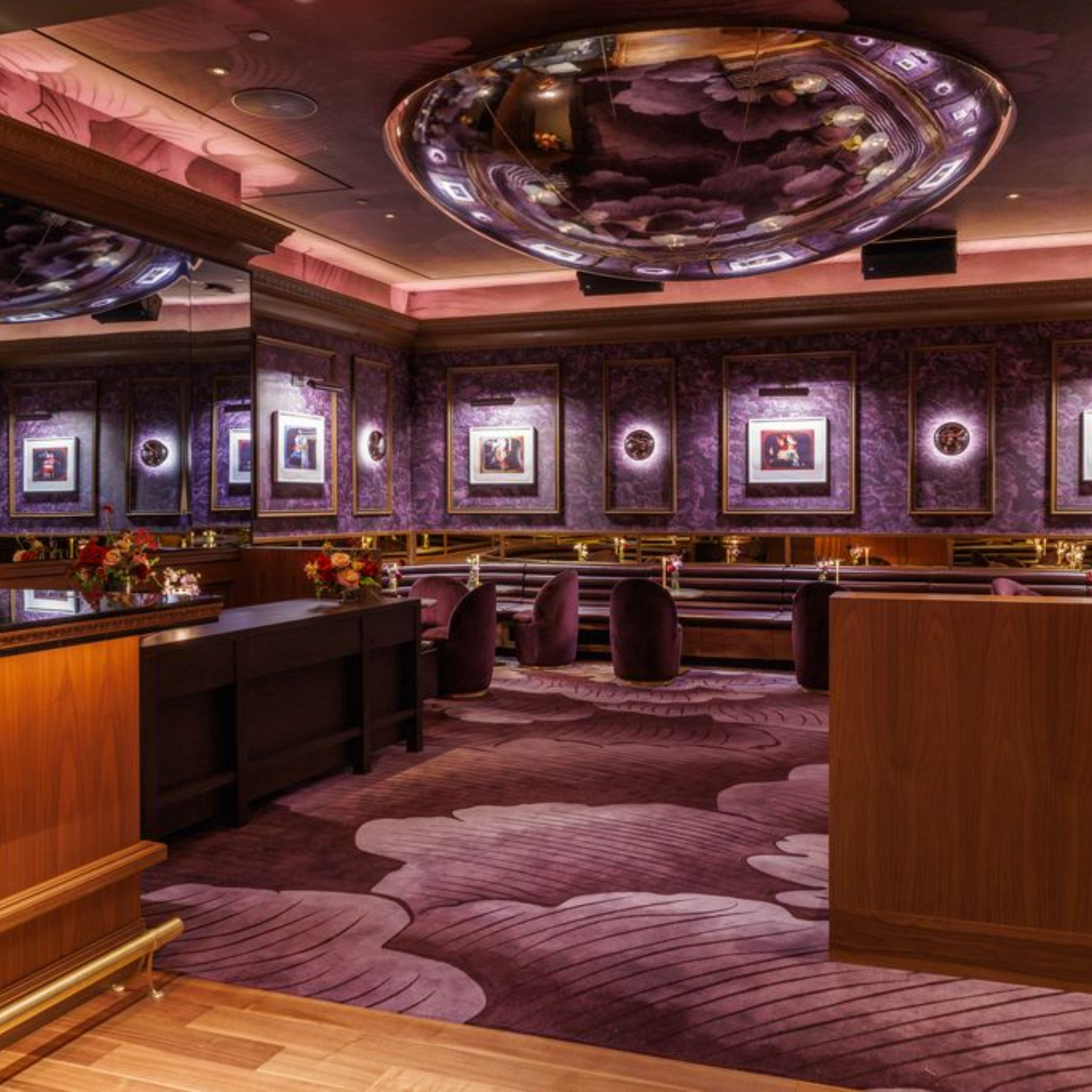 Luxurious lounge with purple décor, abstract carpet, framed artwork, and ambient lighting