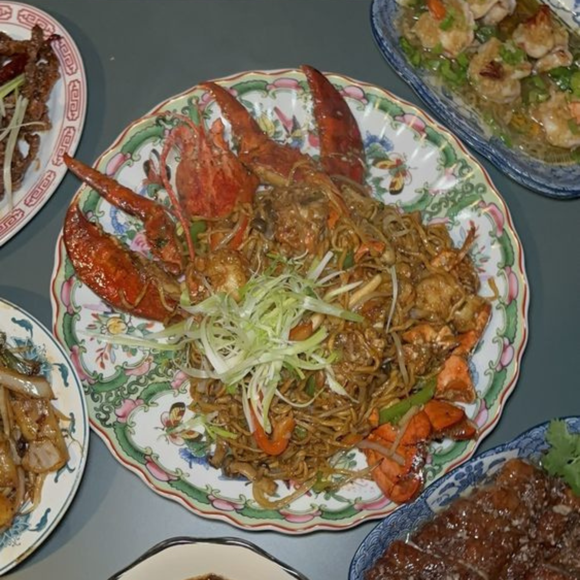 Plate of stir‑fried noodles with lobster and vegetables
