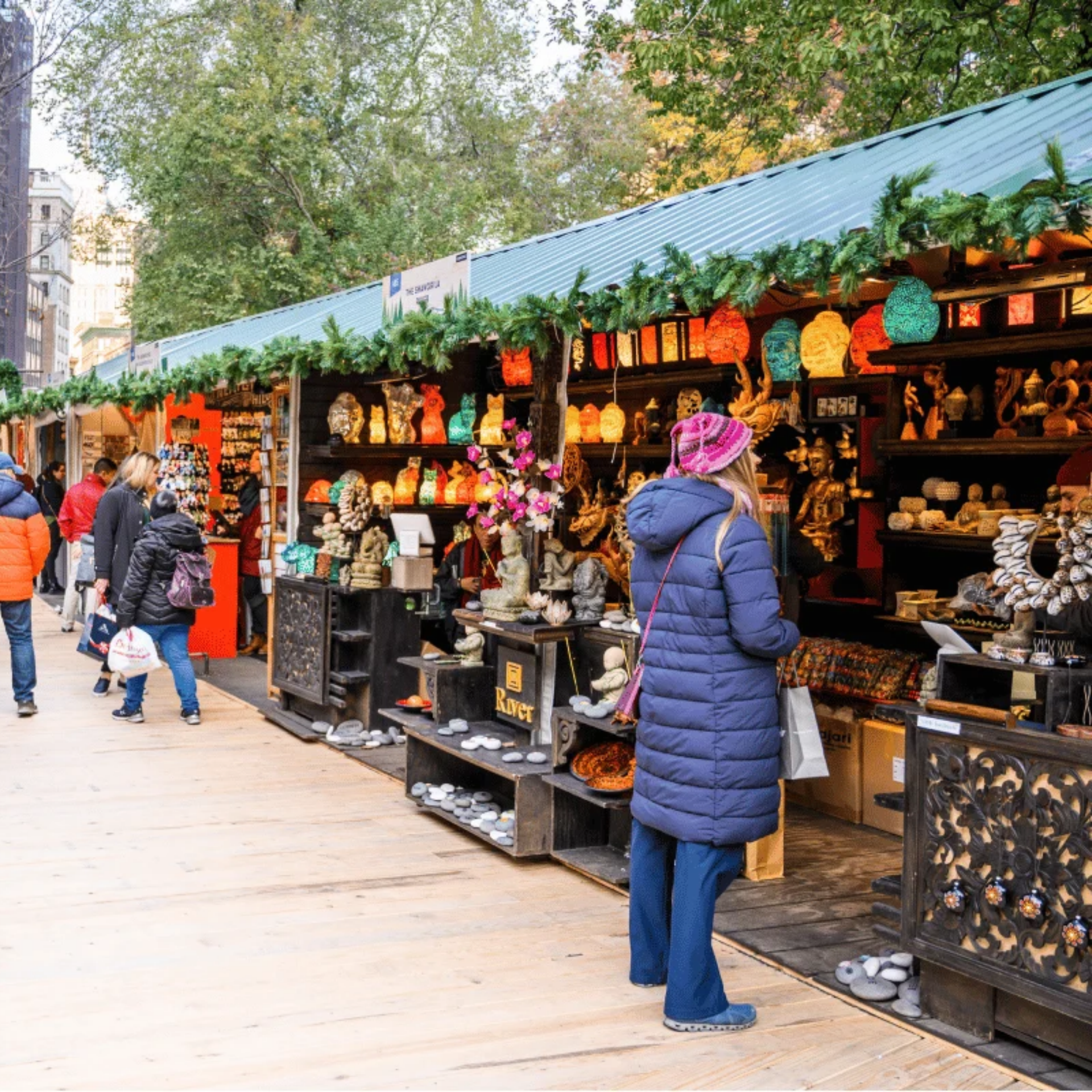 Wooden stalls with lanterns and handcrafted goods at winter market