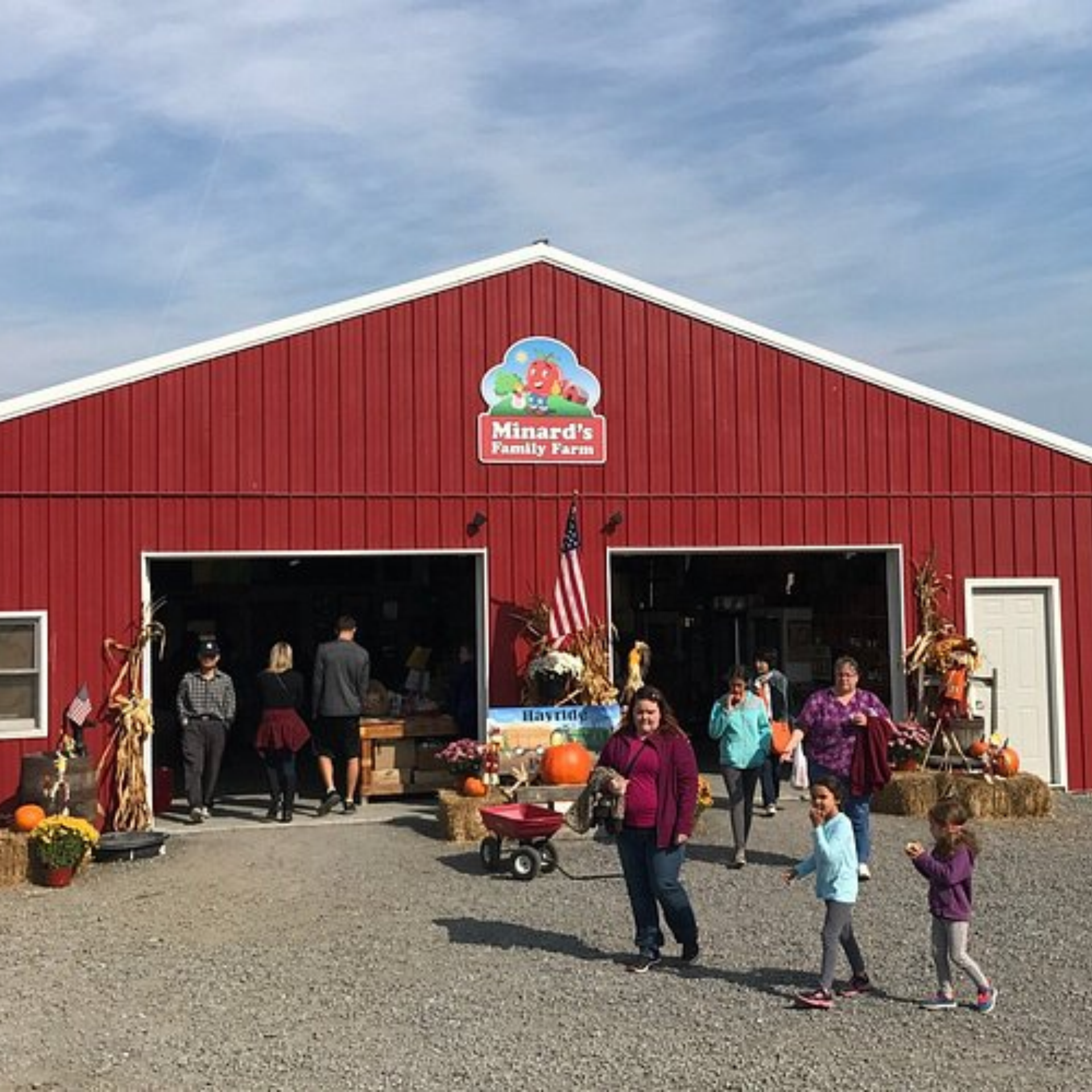 Apple Picking Near NYC: Red barn at Minard’s Family Farm with pumpkins and fall décor