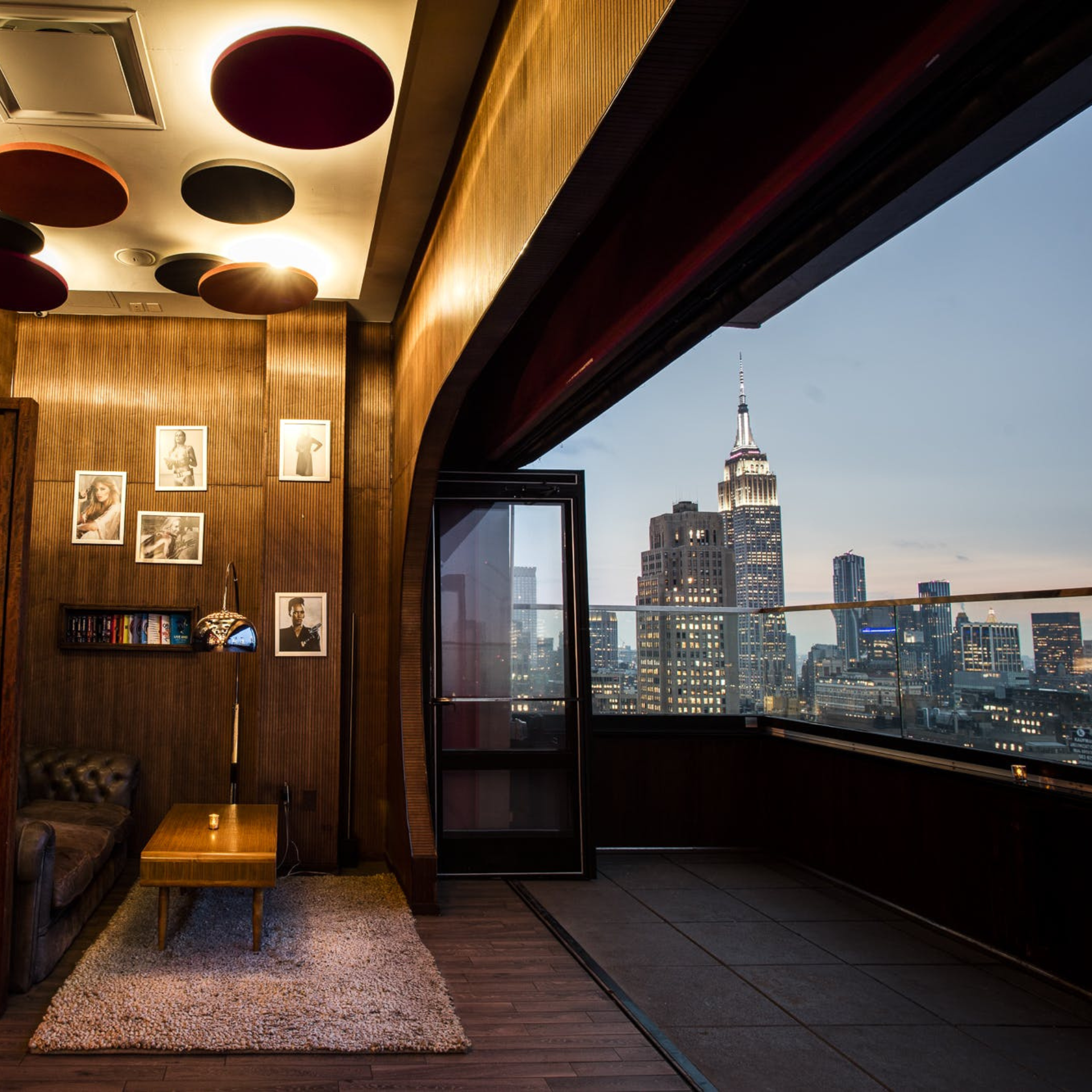 Cozy lounge with Empire State Building view at dusk
