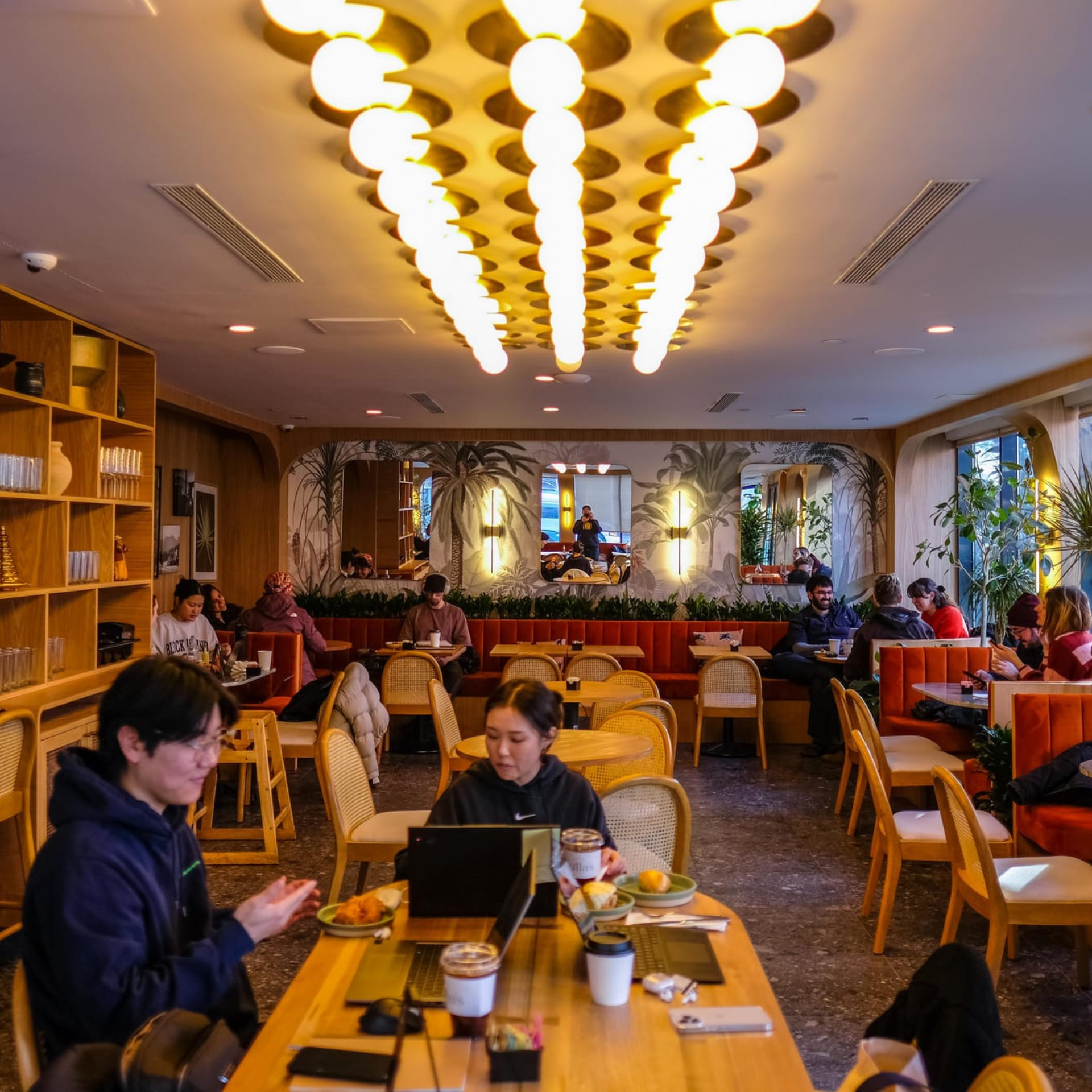 Modern café with warm lighting and tropical décor