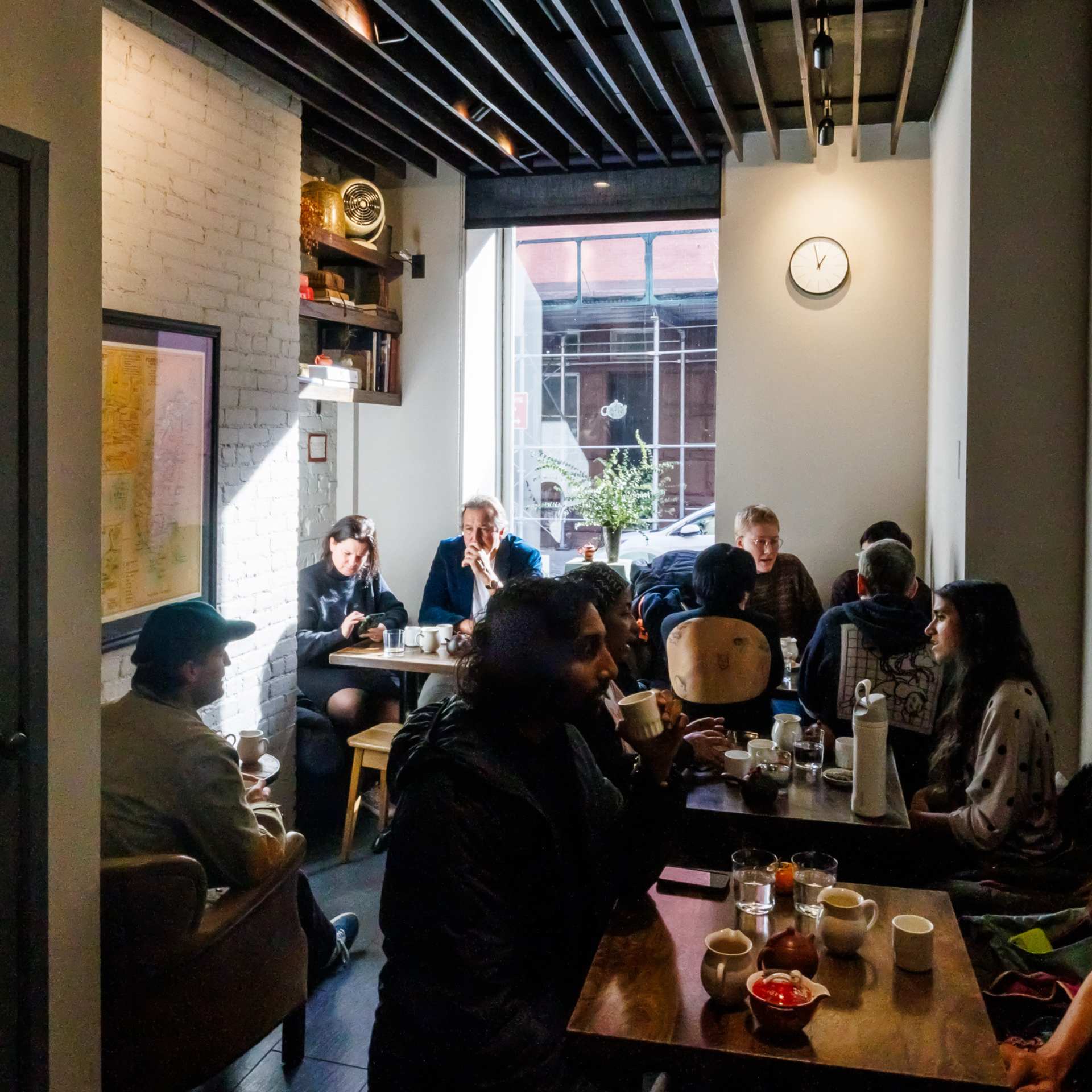 Bustling café with white brick walls and wooden beams