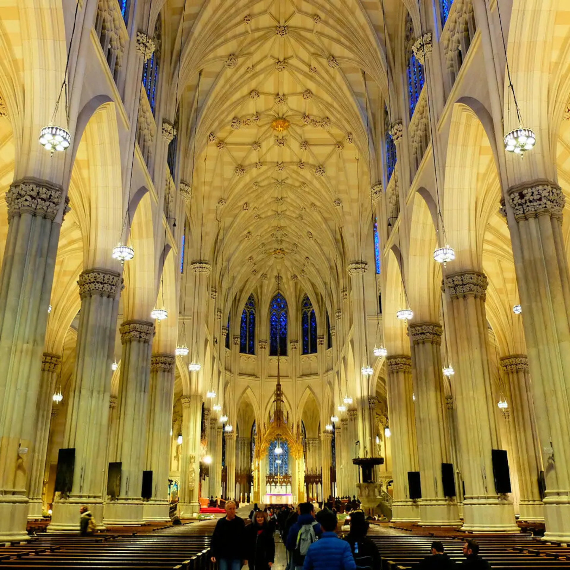 Interior of St. Patrick’s Cathedral in New York City with vaulted ceiling and stained glass windows
