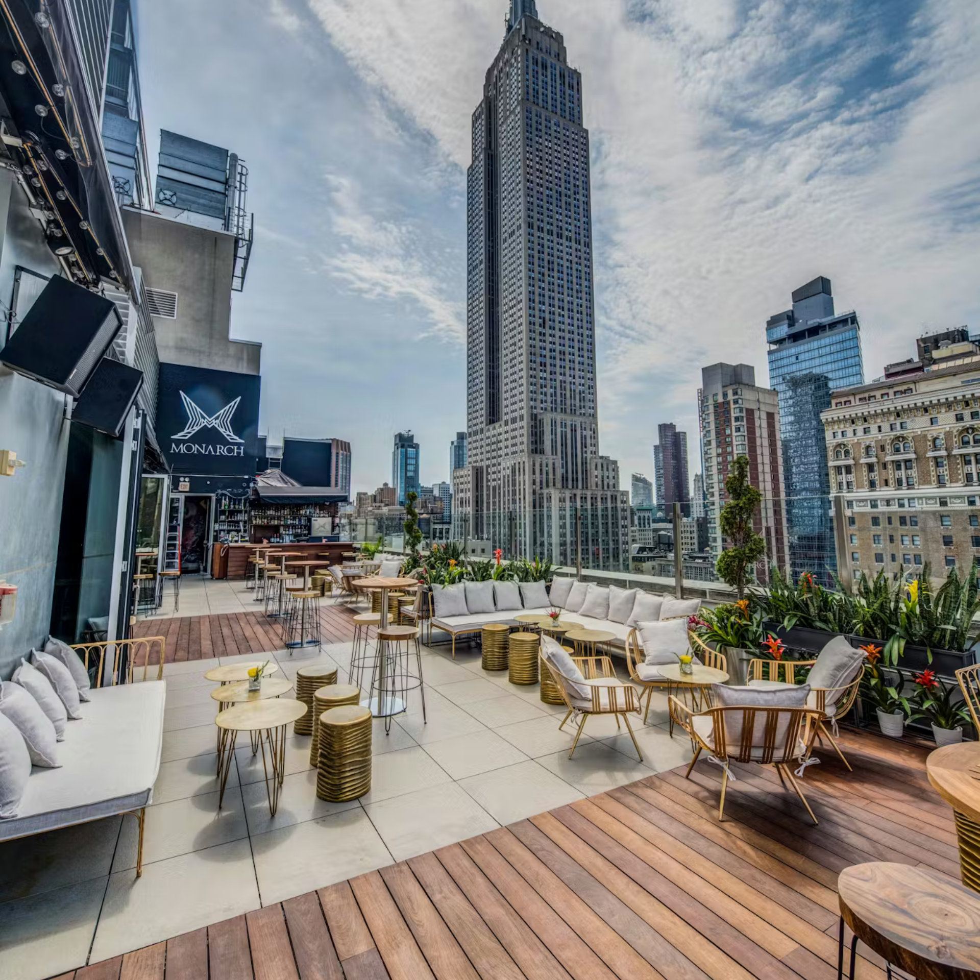 Rooftop lounge with modern seating and Empire State Building view