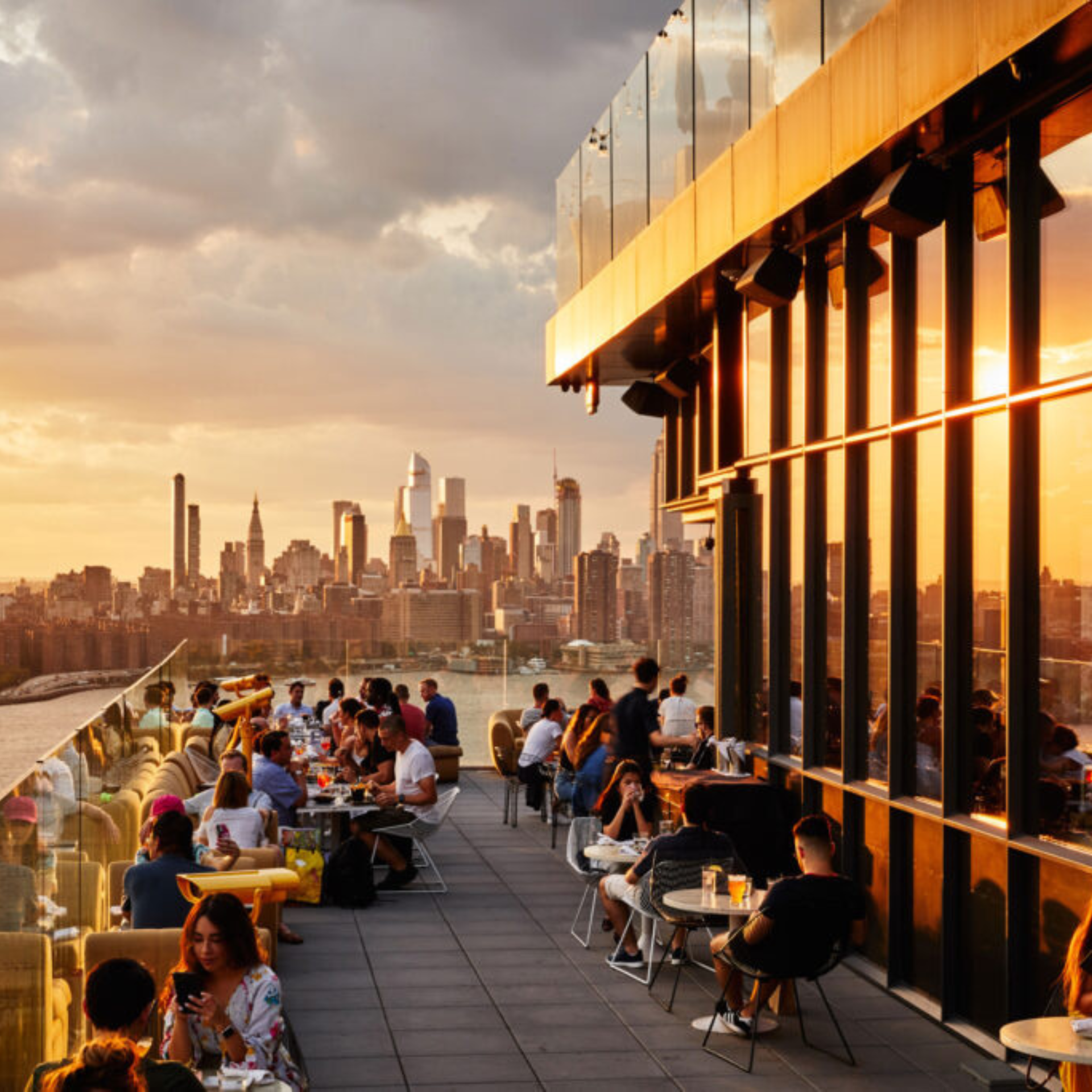 Rooftop dining at sunset with city skyline view