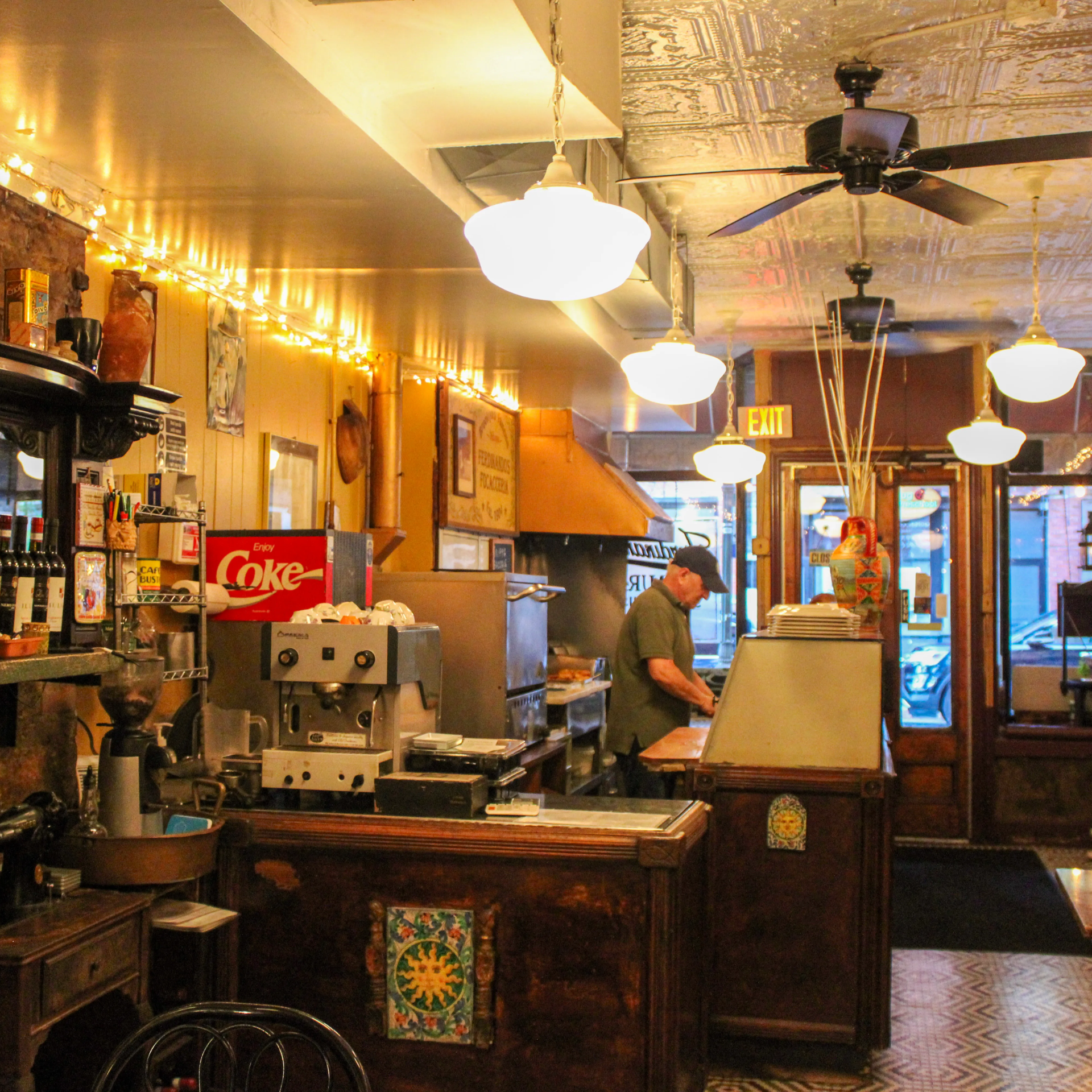 Warm café with string lights, espresso machine, and vintage décor
