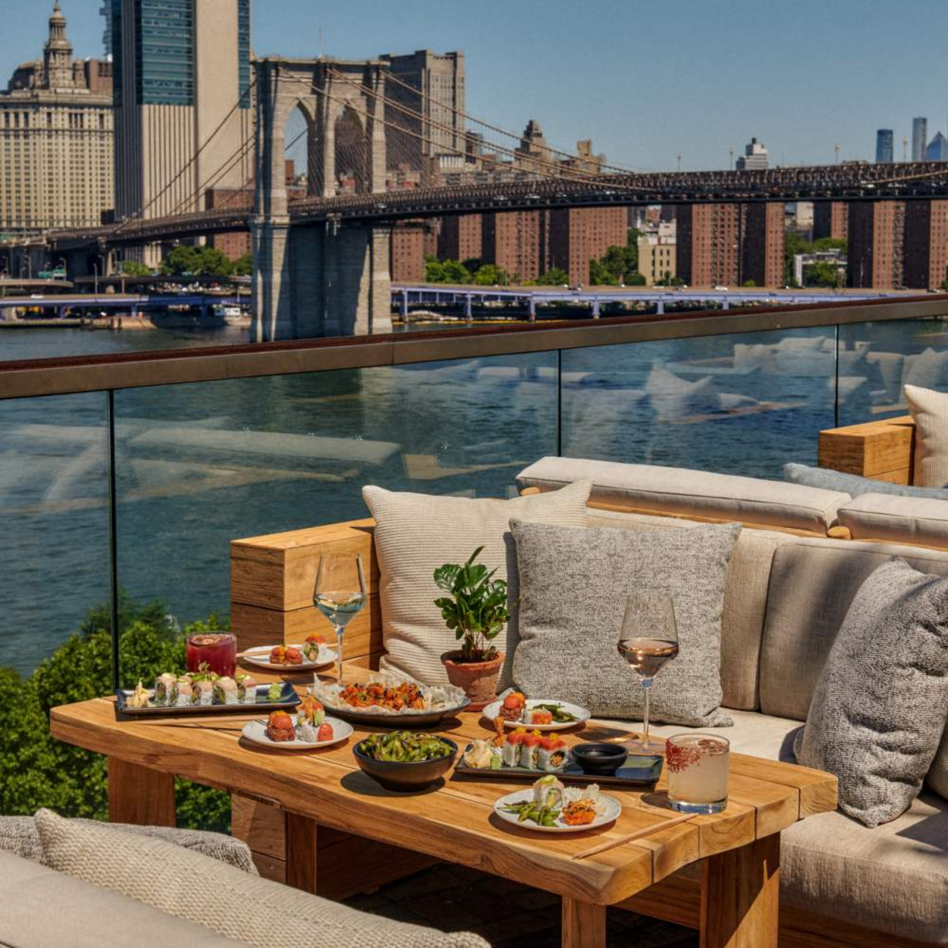 NYC rooftop dining with sushi plates, cocktails, and Brooklyn Bridge river views, scenic spot for food lovers, nightlife, and daily things to do in NYC any day