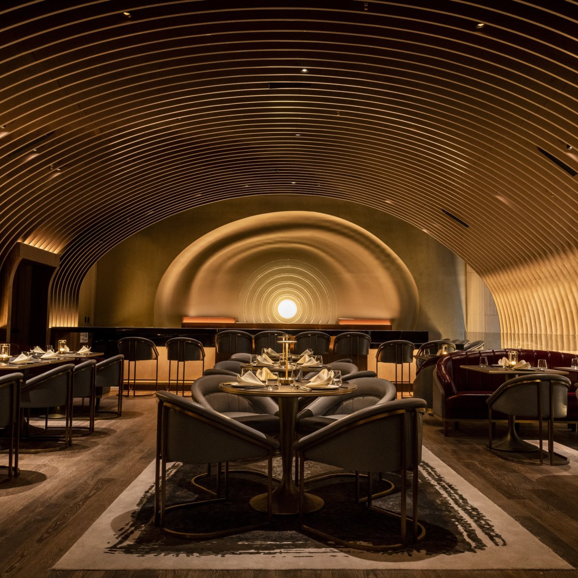 Elegant NYC restaurant interior with curved wooden ceiling design, plush seating, and warm lighting, luxurious dining destination for events, nightlife, and daily things to do in NYC any day