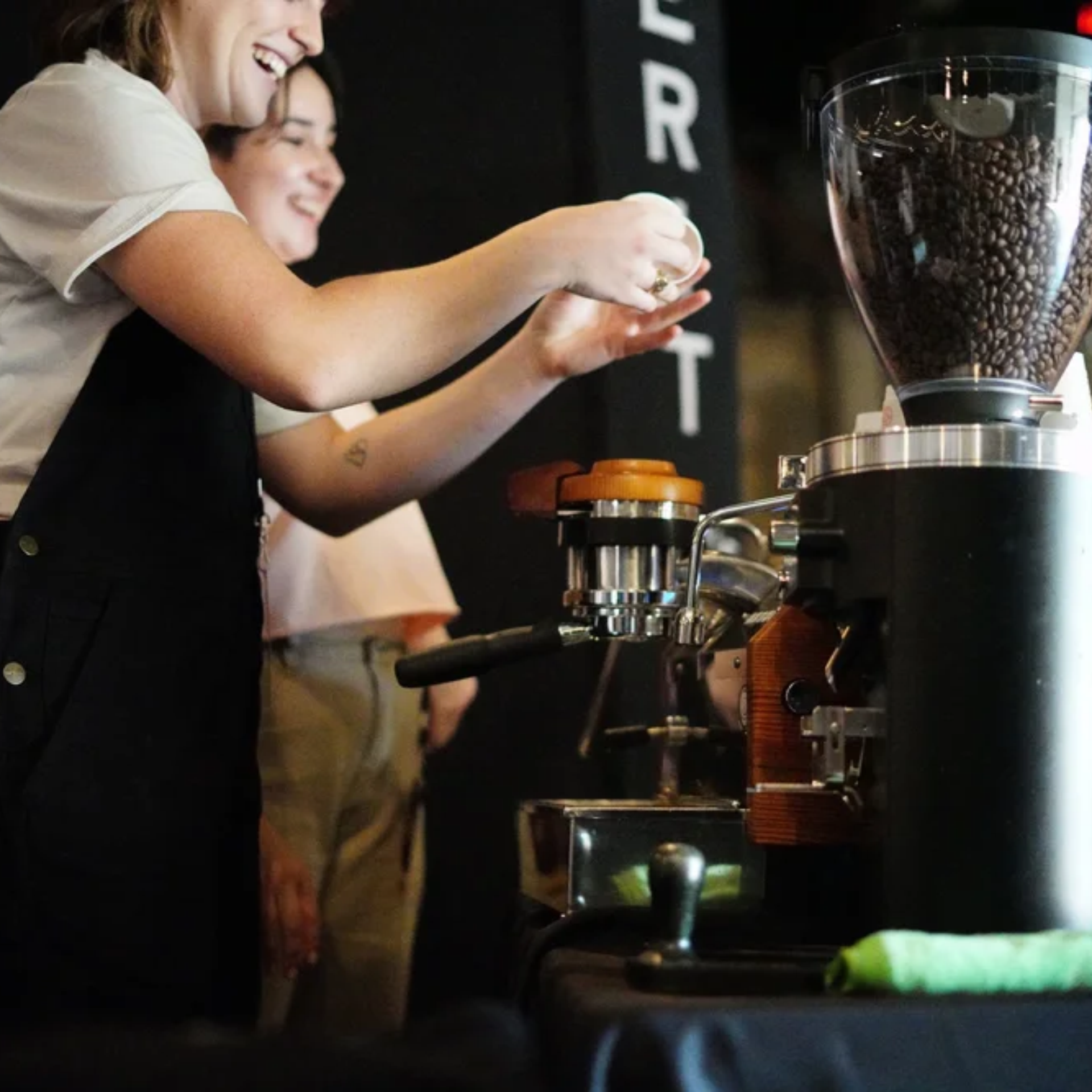 Barista preparing espresso with portafilter at coffee machine