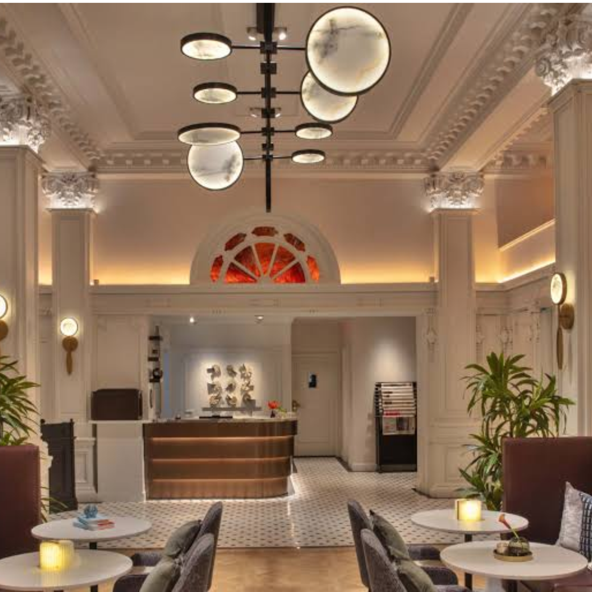 Hotel lobby with curved reception desk and chandelier