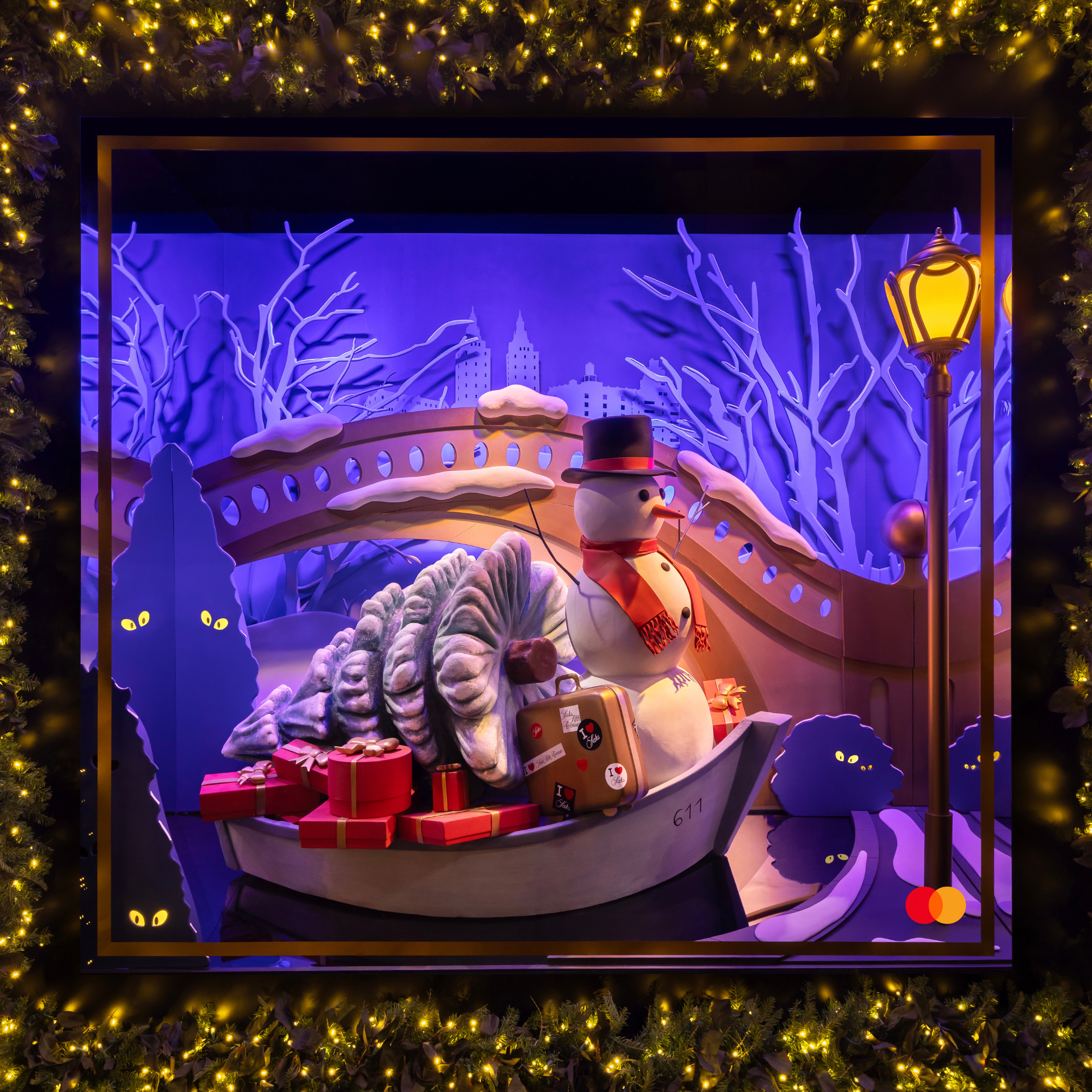 Holiday display with a snowman in a gondola surrounded by gifts, lights, and a whimsical winter backdrop
