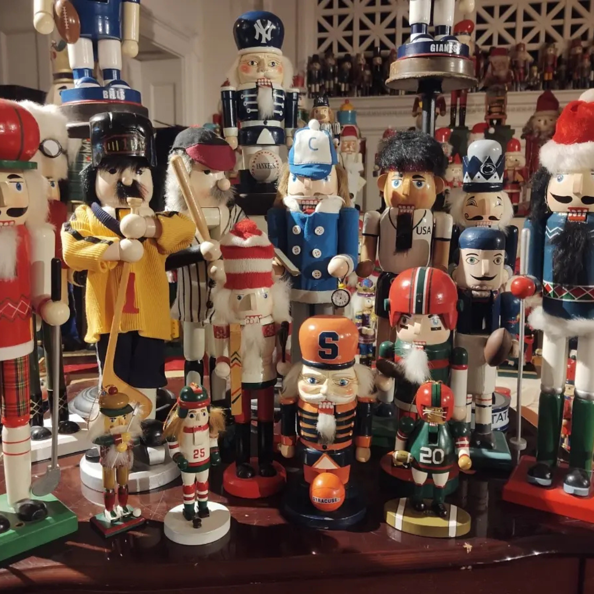 Nutcracker figurines in sports uniforms, holiday outfits, and themed costumes arranged in a festive display
