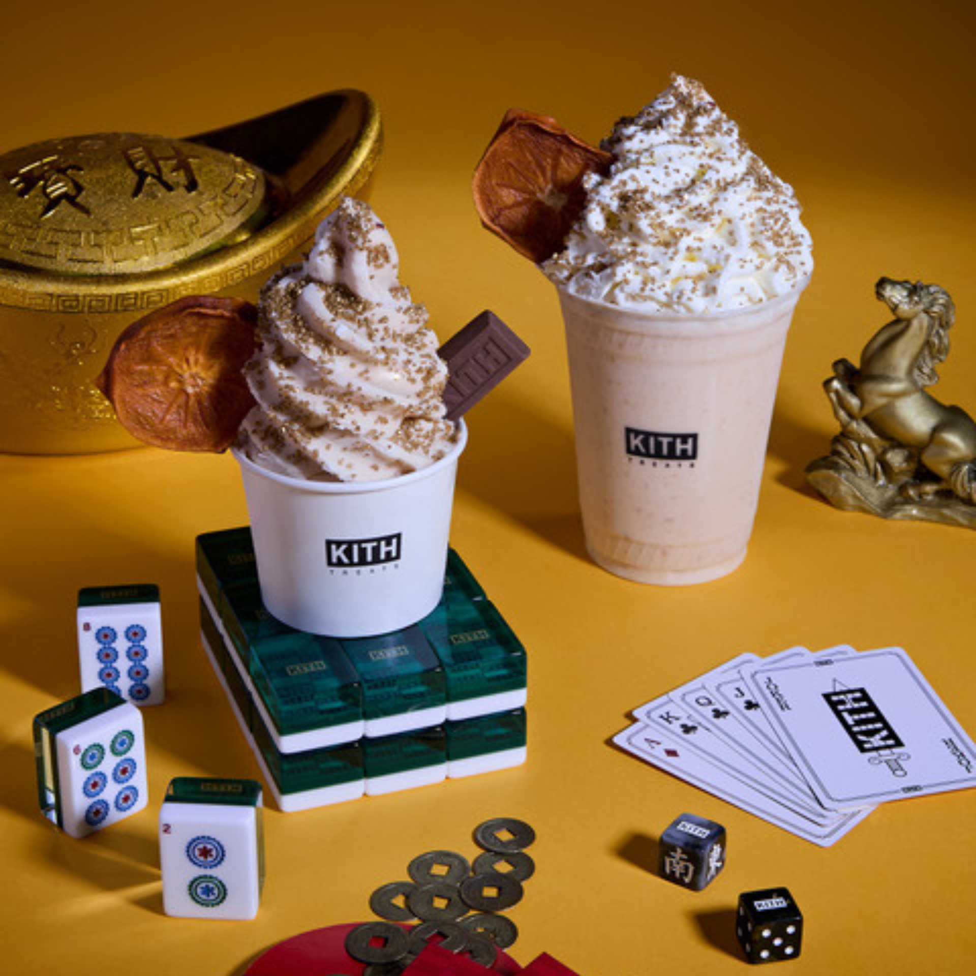KITH Treats ice cream and milkshake with golden sprinkles, chocolate piece, and dried orange slice surrounded by mahjong tiles, coins, and cultural symbols