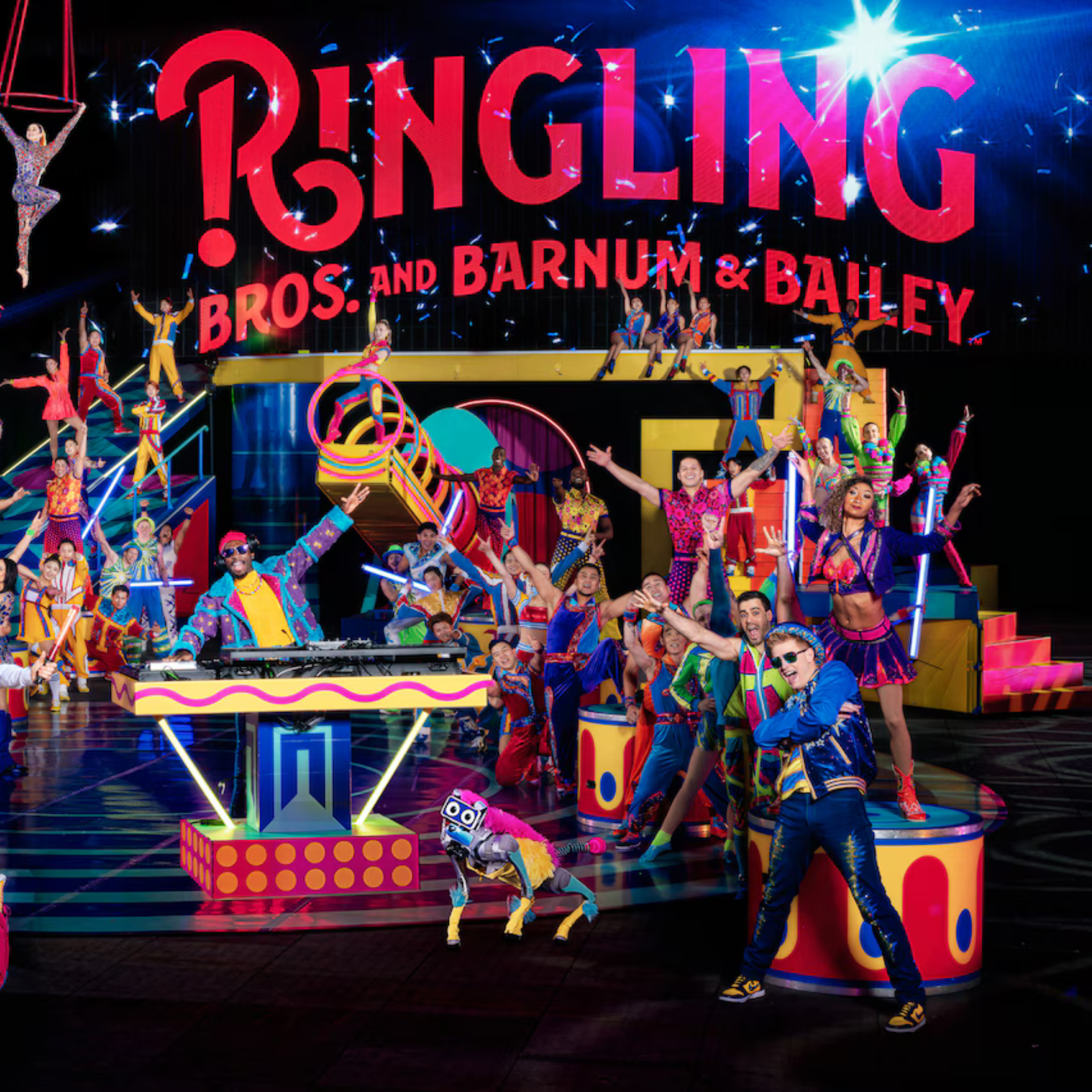 Ringling Bros. and Barnum & Bailey circus show with acrobats, dancers, DJ, and robotic dog on a colorful stage