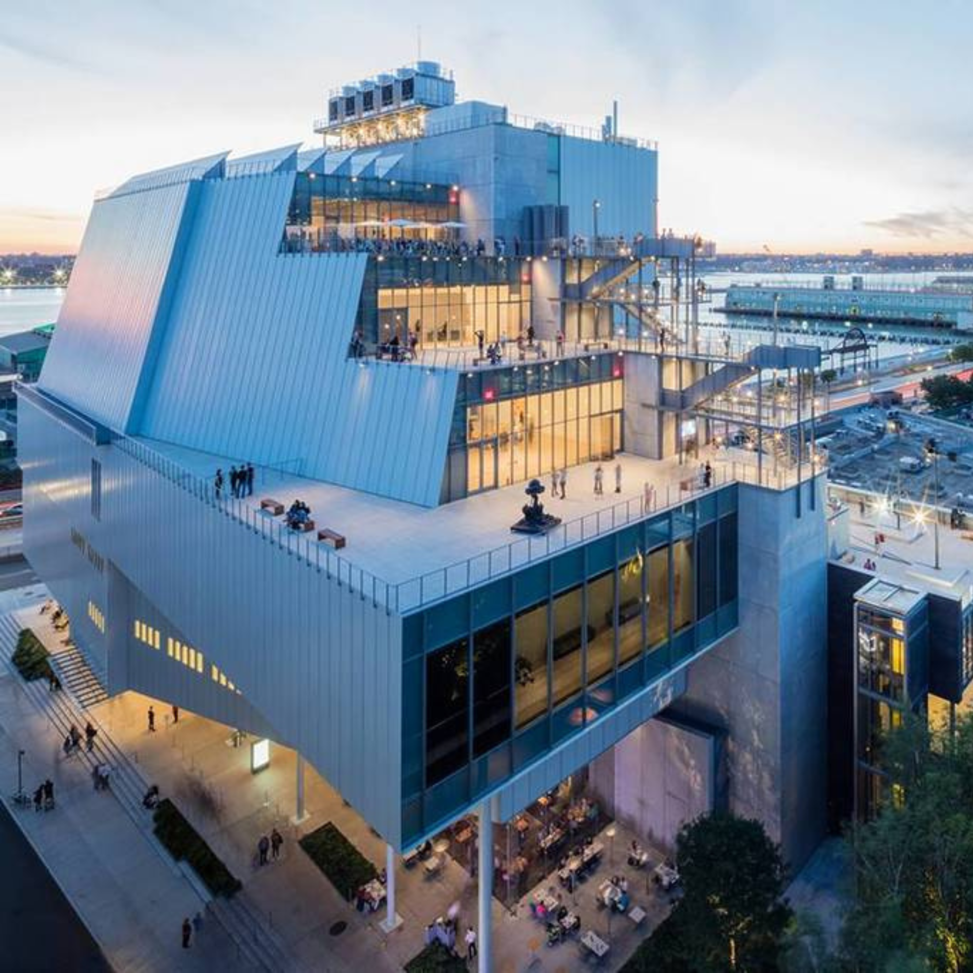 Things to do in NYC: Whitney Museum of American Art in New York City, with cantilevered glass and metal levels, outdoor terraces, and views of the Hudson River