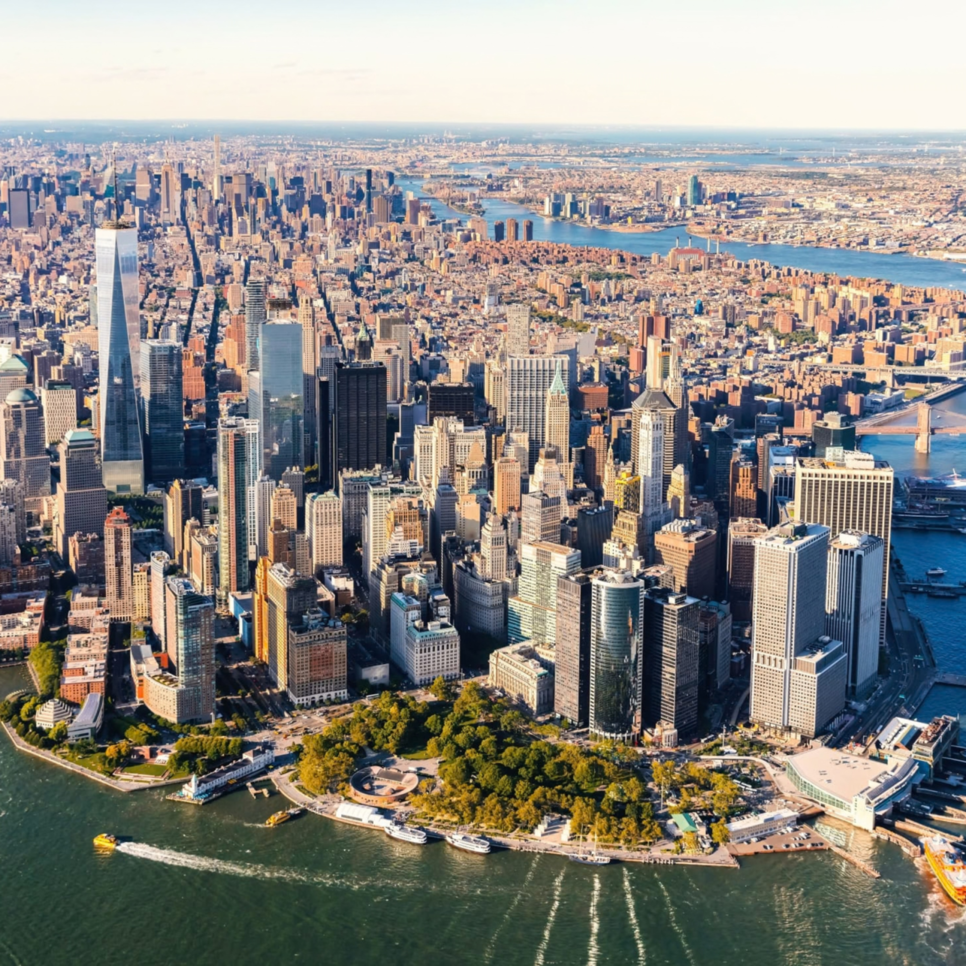 Aerial view of Lower Manhattan skyline with One World Trade Center and Battery Park