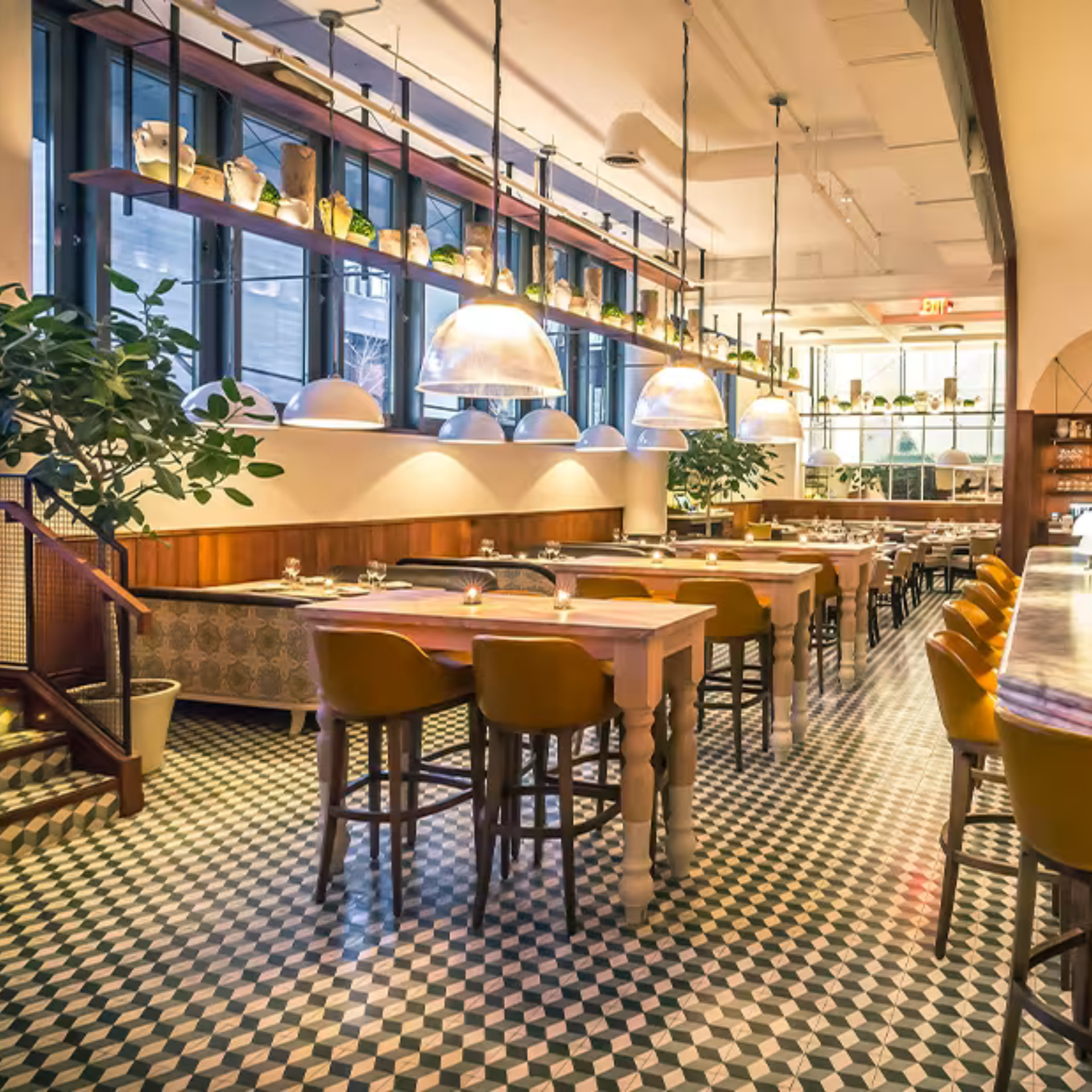 Modern restaurant interior with patterned tile floor, wooden tables, and mustard chairs