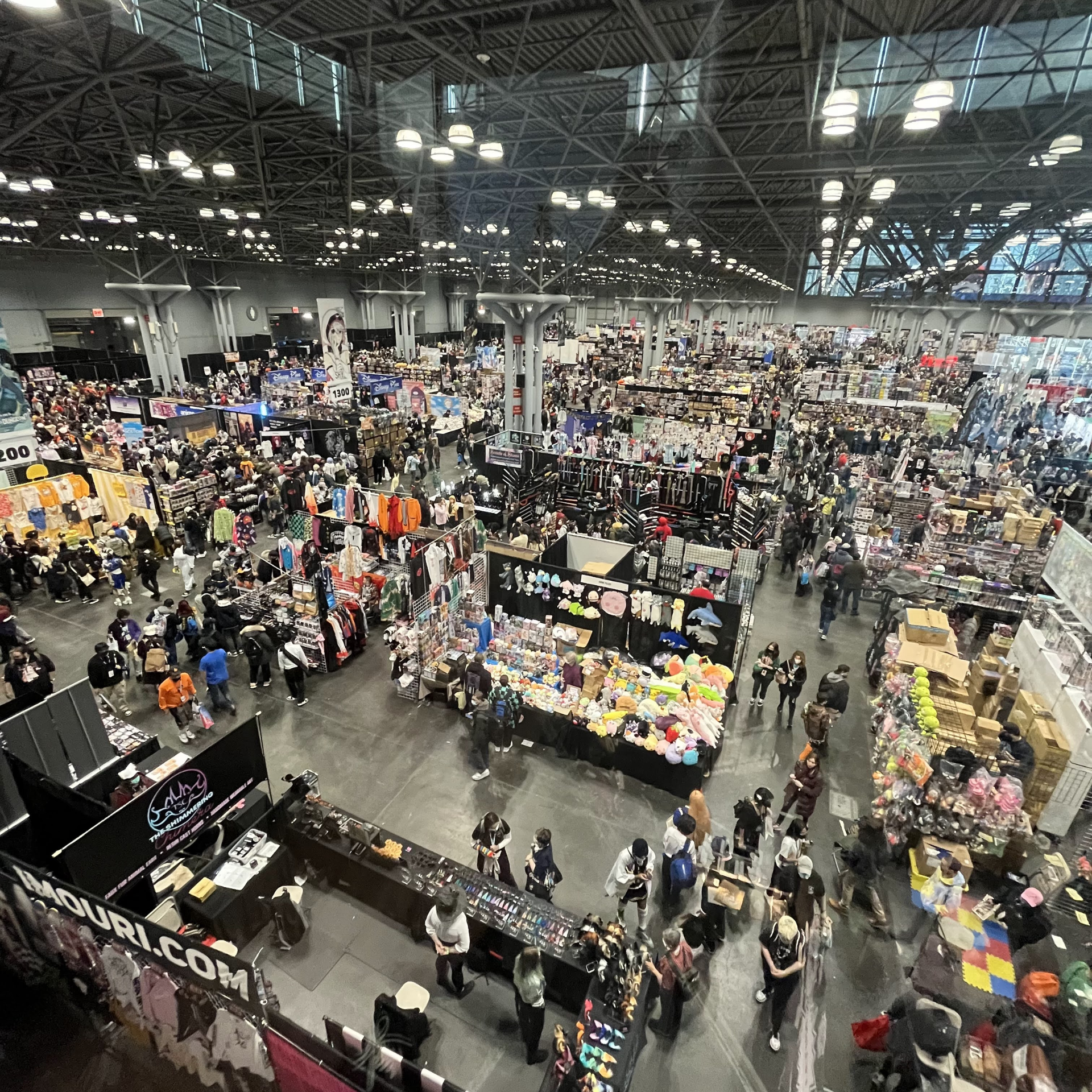 NYC convention hall filled with vendor booths, merchandise, and crowds exploring pop culture expo, lively fandom gathering featured in daily things to do in NYC any day