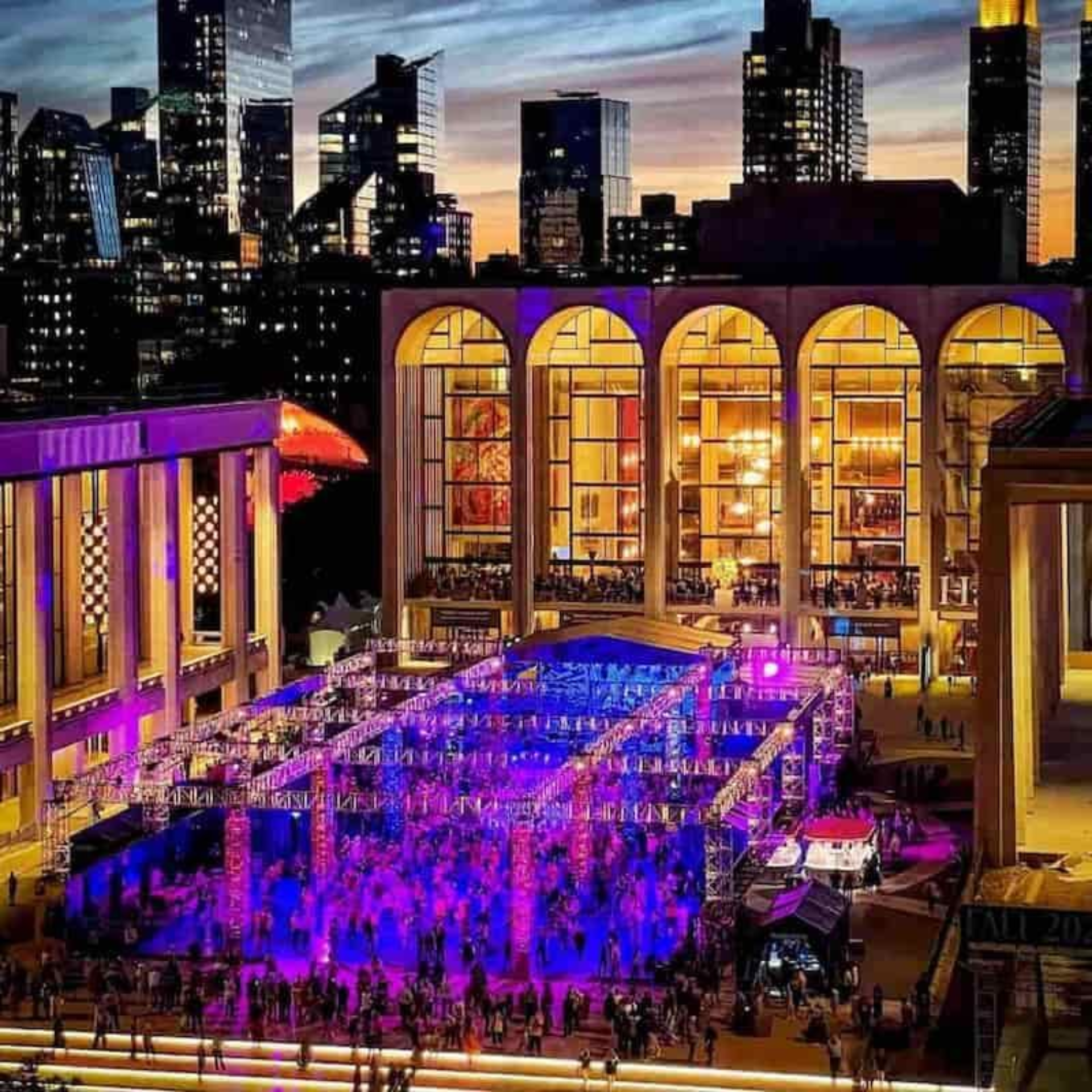 Lincoln Center NYC plaza illuminated with purple and blue lights, outdoor cultural event at Metropolitan Opera House, iconic arts landmark featured in daily things to do in NYC any day