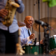 Drummer in striped shirt performing on green drum set with saxophonist in foreground. Things to Do in New York City This August 2026