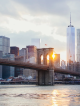Brooklyn Bridge at sunset with Manhattan skyline and One World Trade Center, iconic New York City landmark for walking tours, sightseeing, photography, and daily things to do in NYC