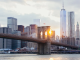 Brooklyn Bridge at sunset with Manhattan skyline and One World Trade Center, iconic New York City landmark for walking tours, sightseeing, photography, and daily things to do in NYC